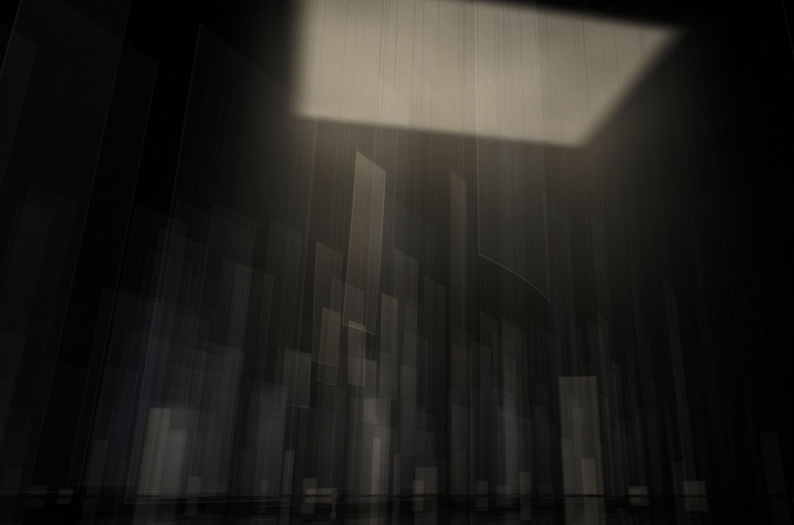 Translucent sheets of paper standing like towers in the dark, lit from a rectangular opening in the roof